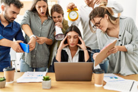 group-of-business-workers-screaming-to-stressed-partner-at-the-office