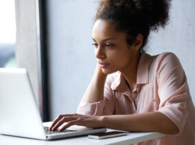 young-black-woman-looking-at-laptop